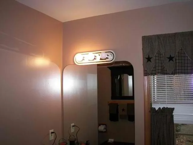 Bathroom with soft taupe painted walls and a vanity light bar